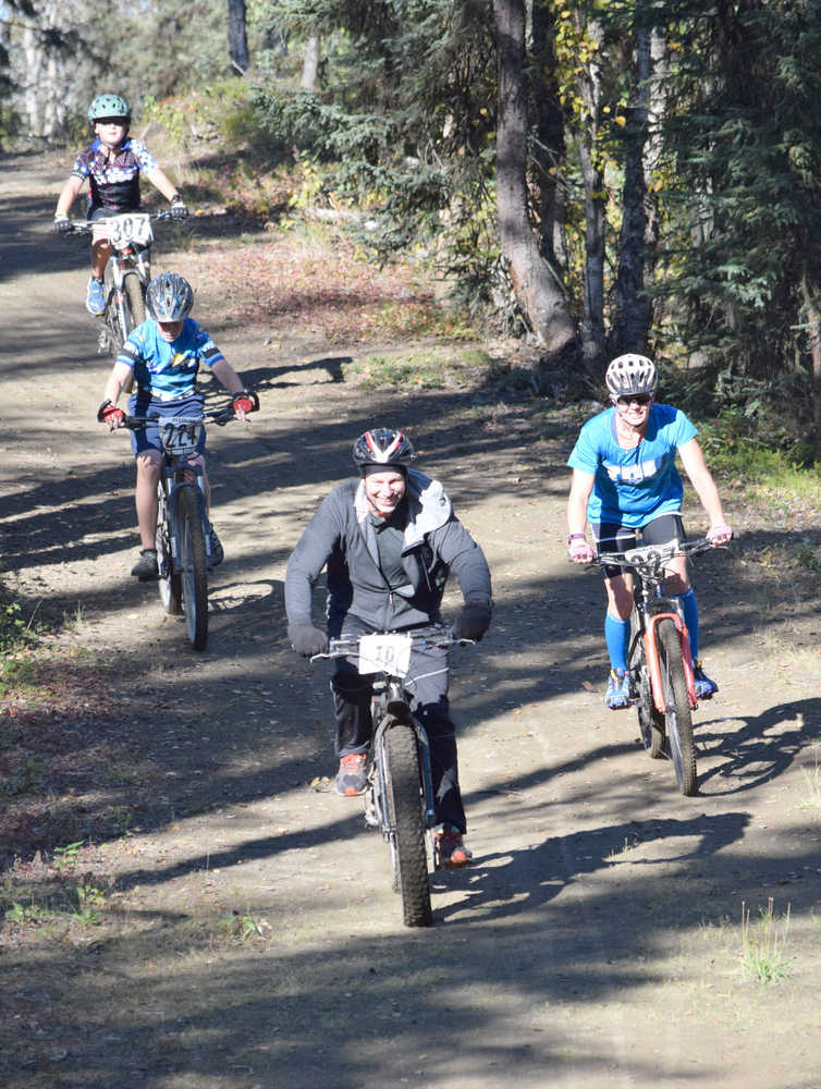Photo by Jeff Helminiak/Peninsula Clarion Carl Kincaid leads Ashley Tonione, Dylan Hogue and Landen Showalter down the beginning of the Goat loop Saturday at Tsalteshi Trails during Psychocross.