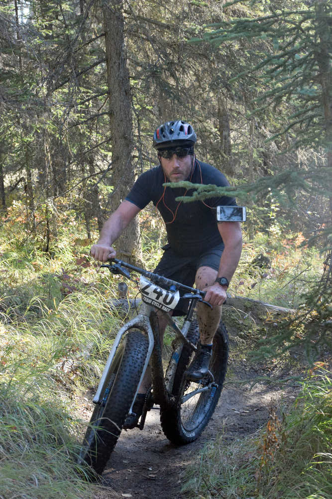 Photo by Jeff Helminiak/Peninsula Clarion Eric Thomason corners through the Mosquite singletrack Saturday at Tsalteshi Trails during Psychocross.