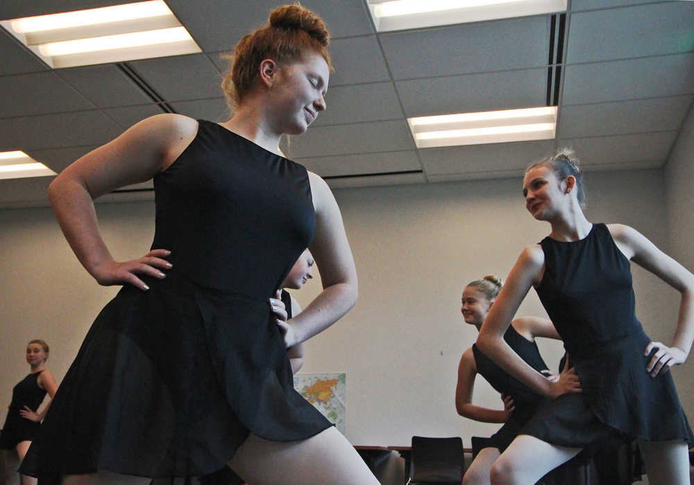 Ben Boettger/Peninsula Clarion Dancers from the Forever Dance Alaska dance school's Flame and Aurora troupes hold the opening poses of a ballet routine they demonstrated at the Soldotna Public Library on Wednesday, Sept. 14. The troupes performed an excerpt from George Balanchine's "Western Symphony" with choreography adapted by ballet instructor Clayton Cunningham.