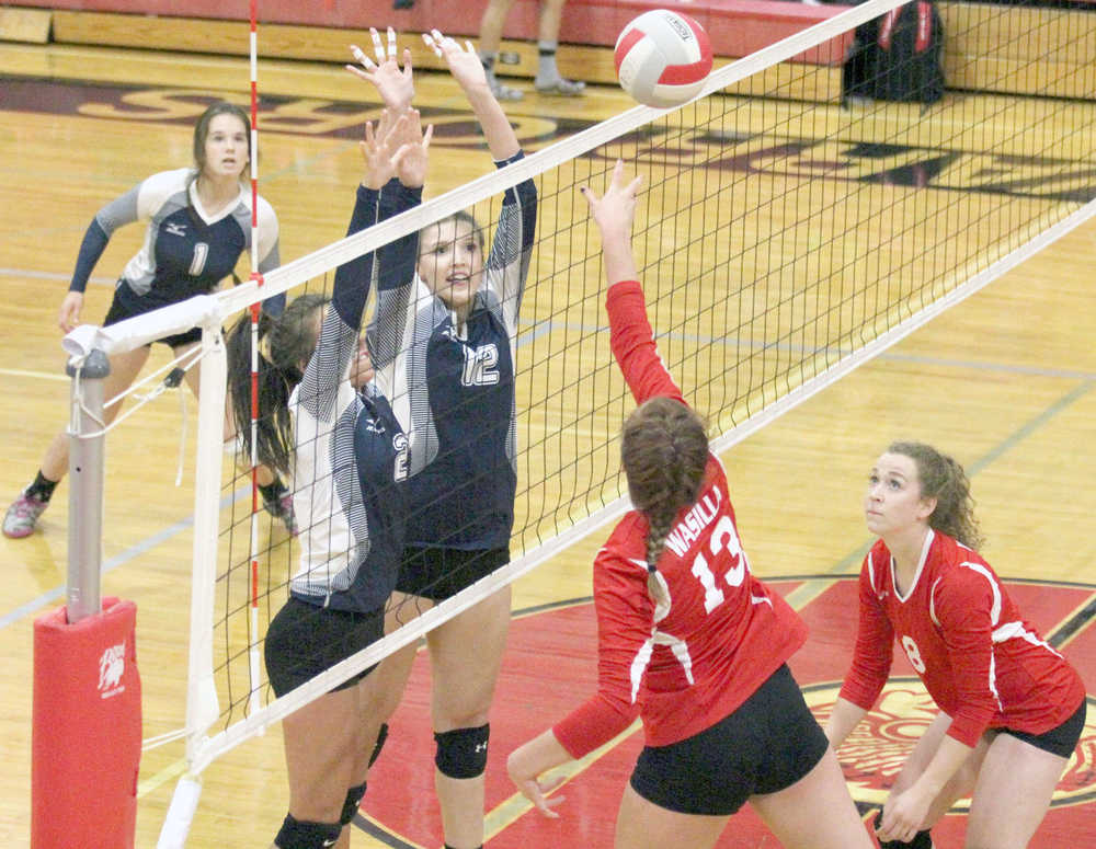 Soldotna's Cally Christianson and Drewe Zeek reach for the block during a 3-0 loss to Wasilla at Wasilla High School Thursday.