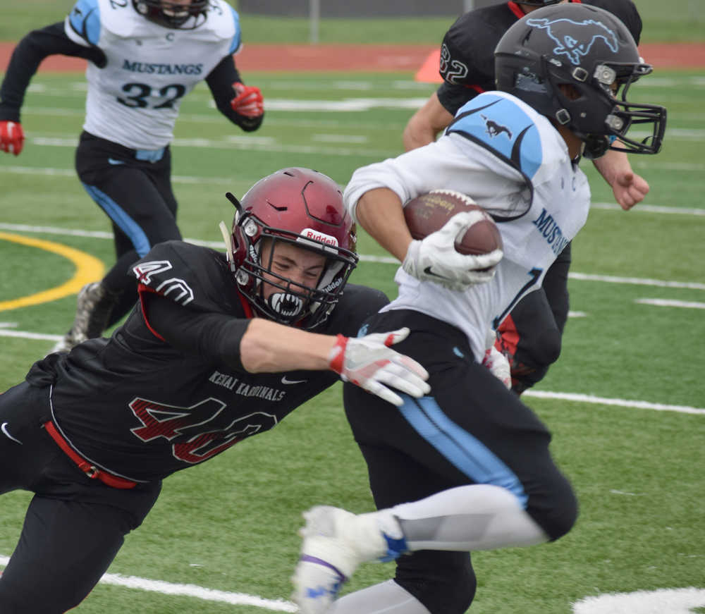 Photo by Joey Klecka/Peninsula Clarion Kenai Central defensive back Rykker Riddall attempts to wrap up a tackle on Chugiak running back Kenny Sison Saturday afternoon at Ed Hollier Field in Kenai.