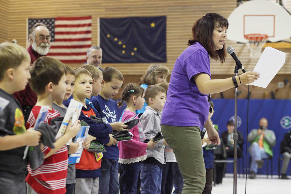 Photo by Kelly Sullivan/ Peninsula Clarion Gretchen Bagley announces how many reading hours first graders logged this summer for the RIGS program during the annual assembly Friday, Sept. 16, 2016 at Kalifornsky Beach Elementary School in Soldotna, Alaska.
