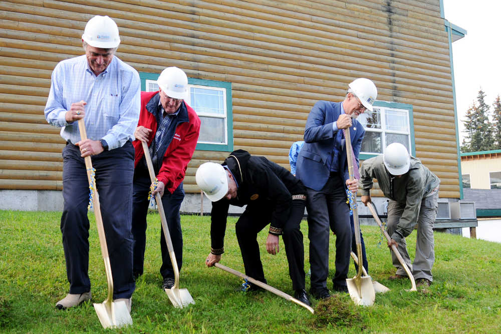 Photo by Elizabeth Earl/Peninsula Clarion Alaska Christian College President Dr. Keith Hamilton (center) bends down to get extra leverage during a groundbreaking ceremony for the new Taikuu dormitory at the college's 15th anniversary celebration Friday, Sept. 16, 2016 near Soldotna, Alaska. The two-year Bible college serves Alaska Natives and this year has 10 students from the Navajo nation in Arizona.