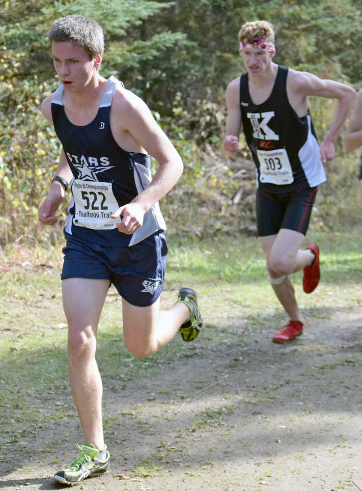 Photo by Jeff Helminiak/Peninsula Clarion Soldotna's Josh Shuler leads Kenai Central's Braden Olson up a hill midway through the Class 4A boys race at the Region III meet at Tsalteshi Trails. Olsen took seventh and Shuler took ninth as both qualified for state.
