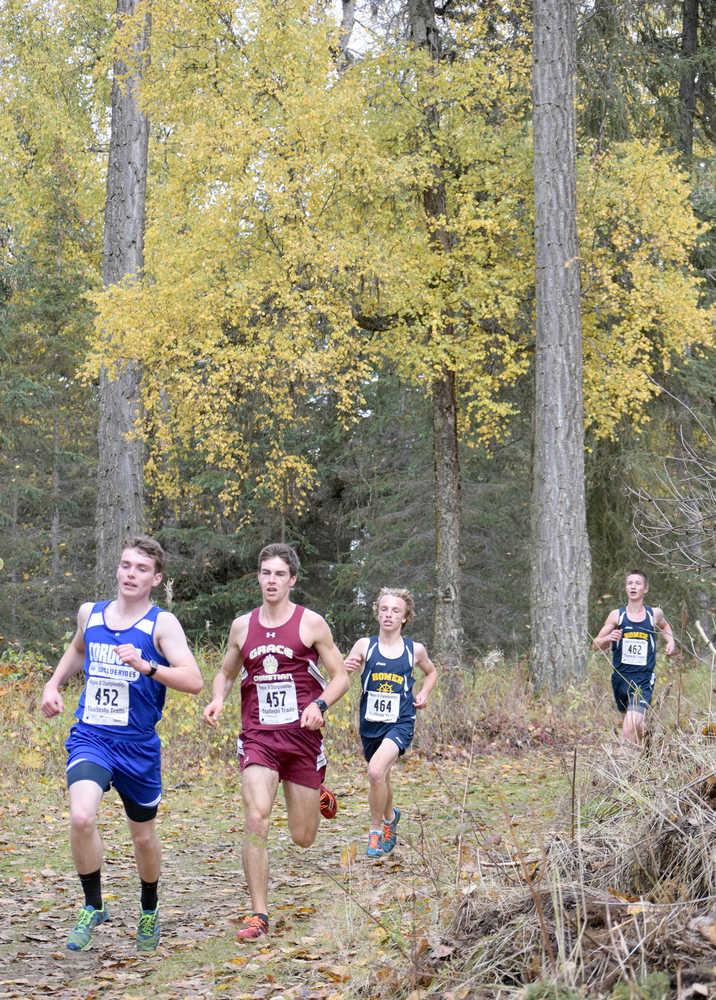 Photo by Jeff Helminiak/Peninsula Clarion Cordova's Zach Hamberger and Grace Christian's Trent Fritzel lead Homer's Jacob Davis and Jordan Beachy down a hill midway through the Class 1-2-3A race at the Region III meet at Tsalteshi Trails on Saturday. Beachy and Davis led Homer to the boys team crown.