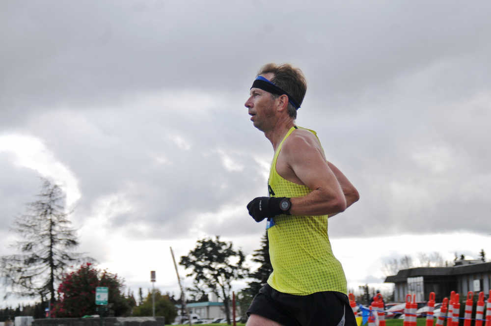 Photo by Elizabeth Earl/Peninsula Clarion John Hellen of Anchorage heads down the home stretch toward the finish line to take first place in the Kenai River Marathon on Sunday, Sept. 25, 2016 in Kenai, Alaska. Hellen, who finished with a time of 3:08:04, will use his finishing time in the Kenai River Marathon when entering the Comrades Marathon in South Africa, the world's oldest and largest ultramarathon, next summer.