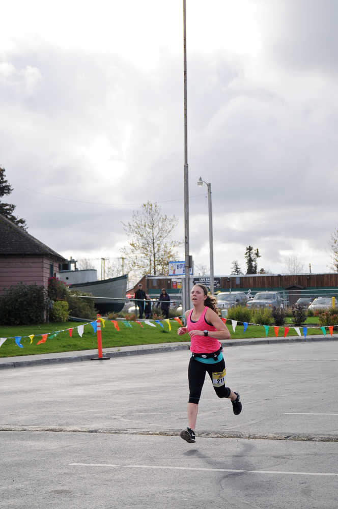 Photo by Elizabeth Earl/Peninsula Clarion Derek Gibson of Soldotna takes a deep breath as he crosses the finish line after running the half-marathon event in the Kenai River Marathon on Sunday, Sept. 25, 2016 in Kenai, Alaska. Gibson took first place in the half-marathon event with a time of 1:16:54, more than 16 minutes ahead of the second-place finisher.
