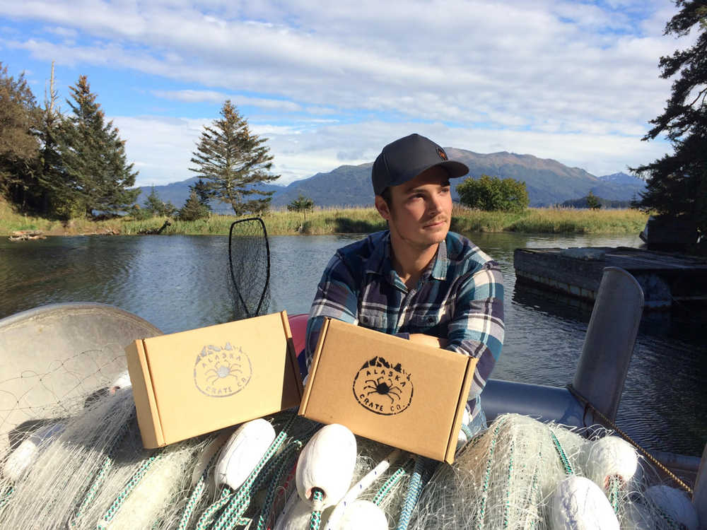 Alaska Crate Company owner Brett Laichak displays boxes that will be used to ship a collection of Alaska items to subscribers. (Photo courtesy Brett Laichak)