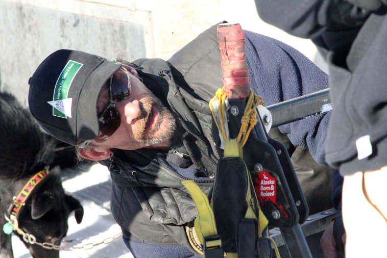 FILE - In this March 6, 2015, file photo, Lance Mackey prepares his sled at the start of the Iditarod Trail Sled Dog Race in Willow, Alaska. The Iditarod Trail Committee on Monday, Sept. 26, 2016, announced that Mackey, a four-time champion, will not participate in the 2017 race because of health problems. (AP Photo/Mark Thiessen, File)