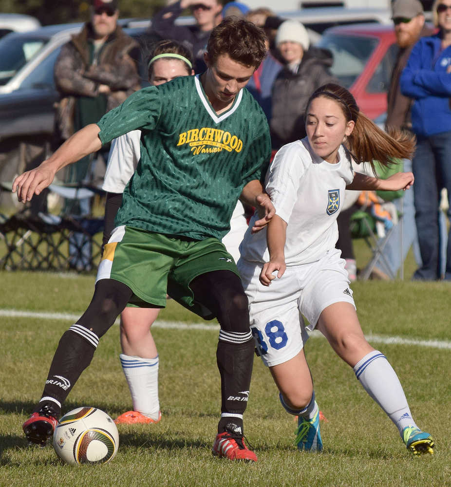 Photo by Joey Klecka/Peninsula Clarion Cook Inlet Academy midfielder Breonna Delon (38) fights for the ball against Birchwood Christian's Bjorn Peterson Thursday at the Aurora Borealis Conference tournament at the Kenai Sports Complex fields.