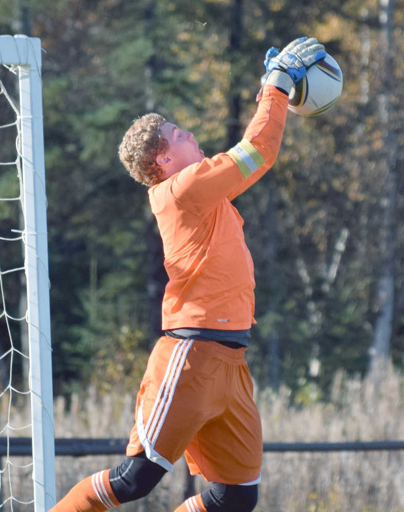 Photo by Joey Klecka/Peninsula Clarion Cook Inlet Academy senior goalkeeper Brady Hammond gets his mitts on a ball early in Thursday's action at the Aurora Borealis Conference tournament at the Kenai Sports Complex fields.
