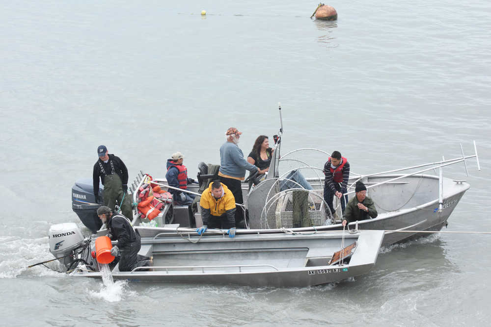 Photo by Megan Pacer/Peninsula Clarion In this July 22, 2016 photo, two boats are towed by members of the Kenai Fire Department and Kenai Police Department. One boat capsized and another came to its rescue on the Kenai River in Kenai, Alaska. The three people in the capsized vessel were all saved from the water, and no one was harmed.