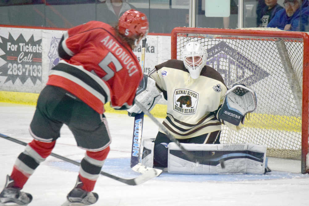 Photo by Jeff Helminiak/Peninsula Clarion Kenai River goaltender Bailey Seagraves prepares to make a glove save on Tyler Antonucci on Friday at the Soldotna Regional Sports Complex.