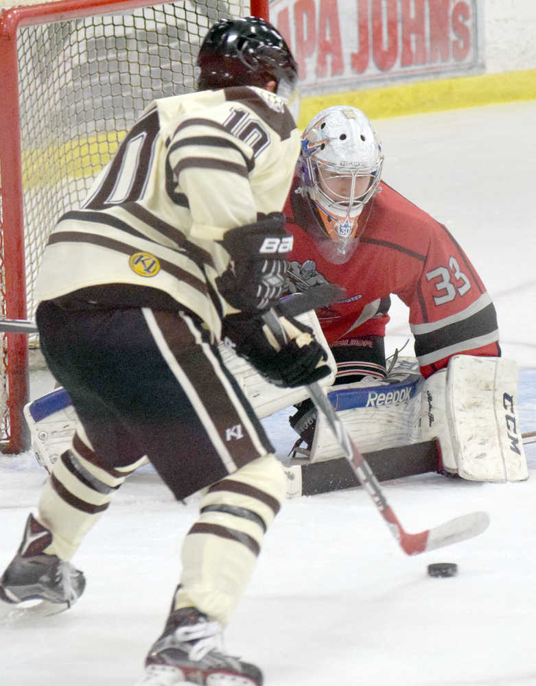 Photo by Jeff Helminiak/Peninsula Clarion New Jersey Titans goaltender Brandon Bussi protects the net from Kenai River forward Chad Lopez on Friday at the Soldotna Regional Sports Complex.