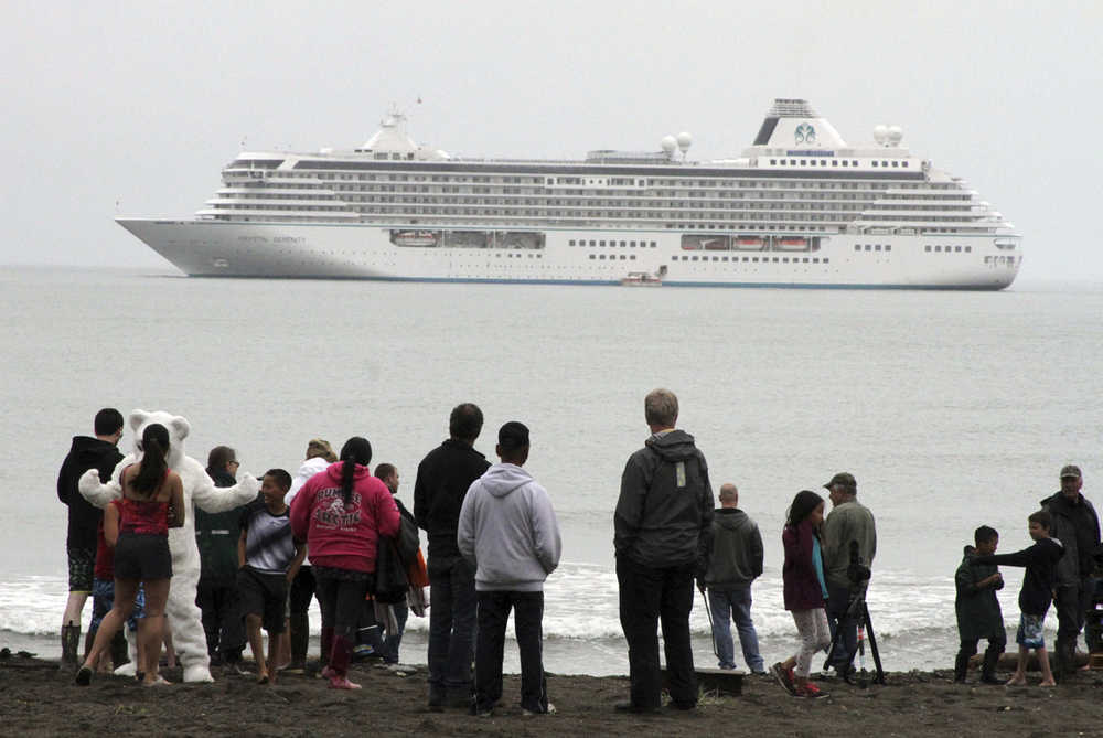 FILE - In this Aug. 21, 2016, file photo people prepare to take a polar plunge in the Bering Sea in front of the luxury cruise ship Crystal Serenity, which anchored just outside Nome, Alaska. The ship made a port call as it became the largest cruise ship to ever go through the Northwest Passage, en route to New York City. An increasing demand for Alaska cruises is prompting some cruise lines to add more and larger vessels to their Far North lineups for the 2017 tourist season. (AP Photo/Mark Thiessen, File)