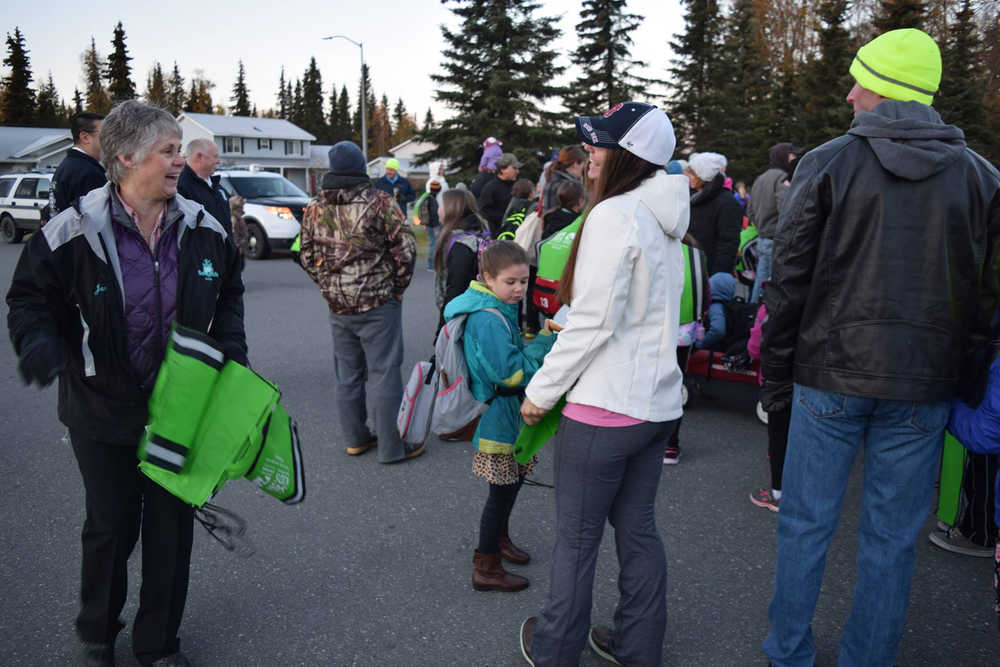 Jane Fellman of Safe Kids Kenai Peninsula greets students and parents during Walk Your Child to School Day Tuesday in Soldotna.