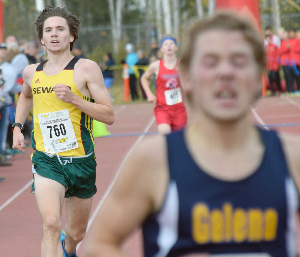 Photo by Joey Klecka/Peninsula Clarion Seward senior Hunter Kratz finishes second to Galena's Hunter Moos in the 1-2-3A boys race at the Bartlett High School trails in Anchorage.