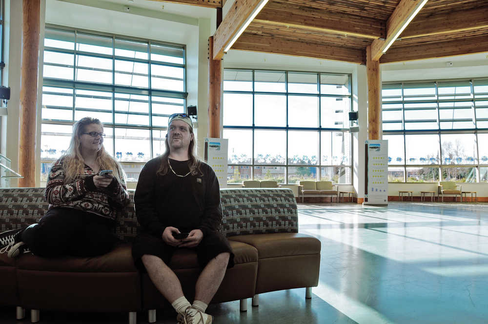 Photo by Elizabeth Earl/Peninsula Clarion Bob Patterson and his daughter Rowen Patterson, both Kenai, wait in the lobby of the Kenaitze Indian Tribe's Dena'ina Wellness Center on Thursday, Oct. 6, 2016 in Kenai, Alaska. With an Americorps grant, the Kenaitze Indian Tribe will soon add a legal fellow to its center, with free services available to low-income and some qualifying customers.