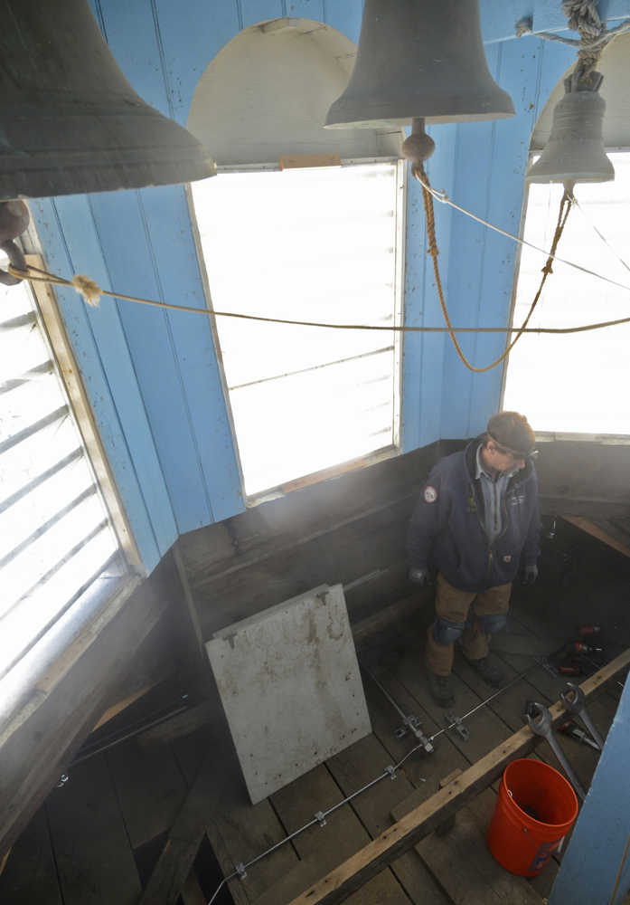 Electrician Richard Cutter works on piping in the bellfry of Kenai's Holy Assumption of the Virgin Mary Russian Orthodox Church, where he's helping install a new fire supression system, on Thursday, Oct. 6 in Kenai.