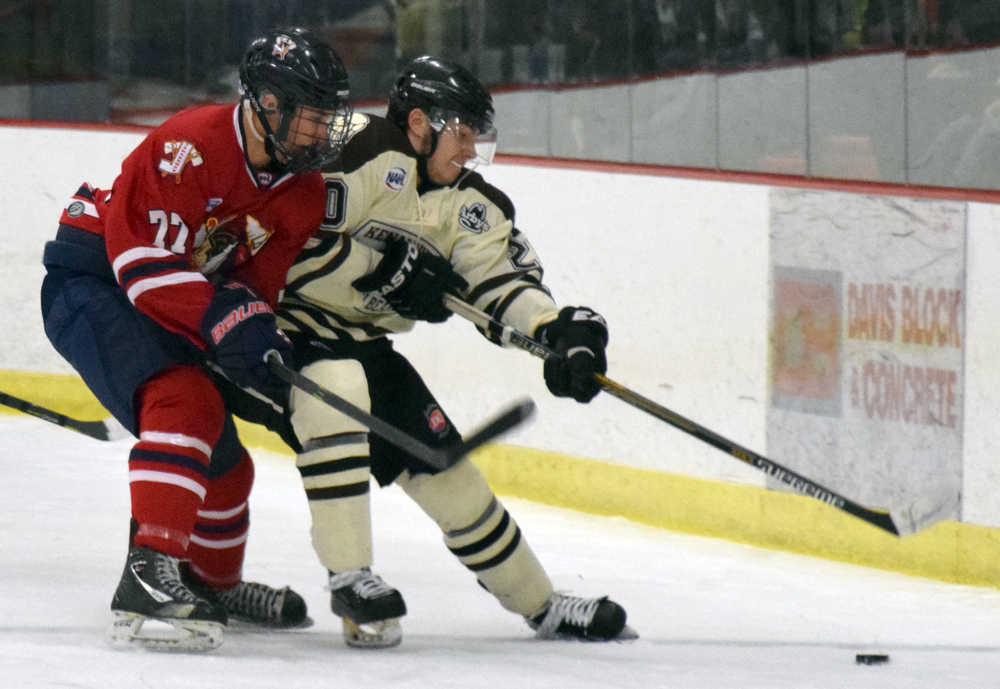 Photo by Jeff Helminiak/Peninsula Clarion Kenai River defenseman Shayne Monahan tries to keep Johnstown (Pennsylvania) forward Mitchell Hale away from the puck Friday at the Soldotna Regional Sports Complex.