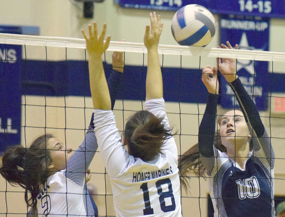 Photo by Joey Klecka/Peninsula Clarion Soldotna sophomore Aliann Schmidt (10) and junior Cally Christianson team up to score on Homer sophomore Calla Seay (18) Friday at Soldotna High School.