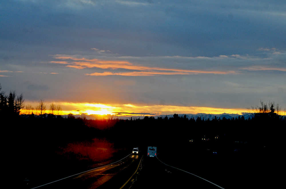 Photo by Elizabeth Earl/Peninsula Clarion Sunrise peeks over the top of the mountains to light up Bridge Access Road on Monday, Oct. 10, 2016 in Kenai, Alaska. Sunrise is migrating later in the morning as the winter approaches. The sun rose at 7:35 a.m. in Kenai on Monday and will rise two to three minutes later every morning until the winter solstice on Dec. 22, when the days will get longer again, according to the U.S. Navy's sunrise and sunset tables.