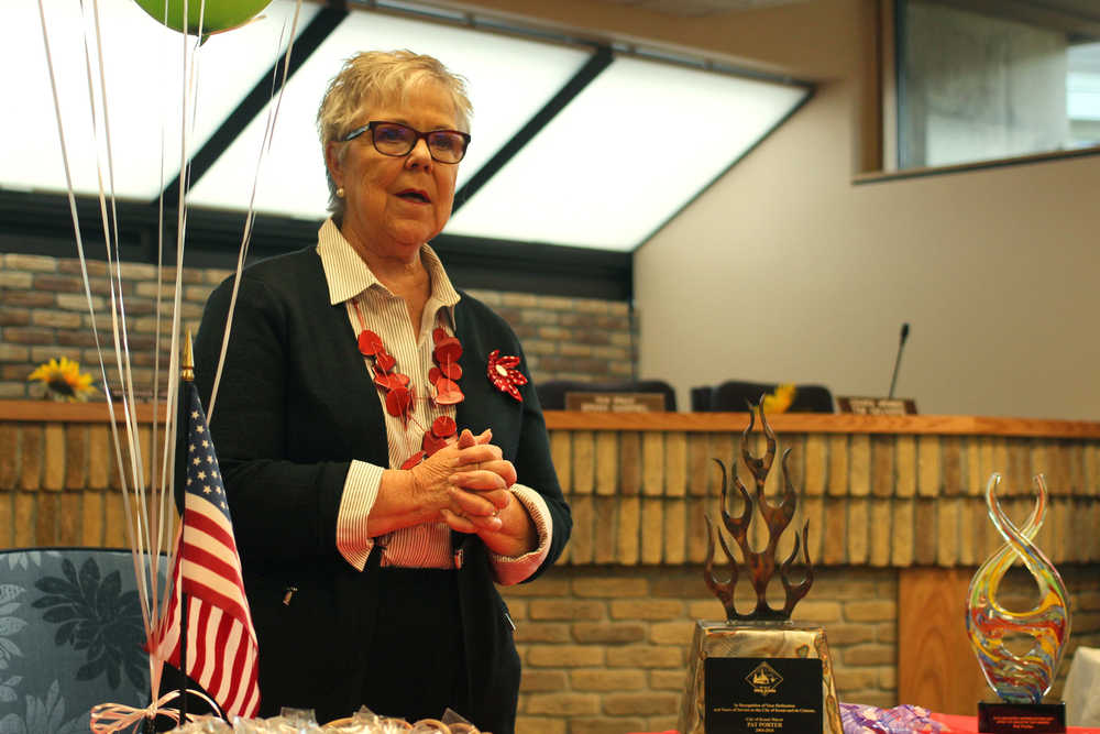 Photo by Ben Boettger/Peninsula Clarion Kenai Mayor Pat Porter, who is finishing her 12 years as mayor and flying to her new home in Texas Thursday morning, speaks to attendees at her farewell party Wednesday, Oct. 12, 2016 in the Kenai City Council Chambers in Kenai, Alaska. Prior to her speech, council members Tim Navarre and Brian Gabriel presented Porter with an appreciation tropy, (pictured closest to Porter) created by Scott Hamman of Kenai's Metal Magic welding and blacksmith shop, and a blown-glass "Spirit of Industry" trophy awarded during Kenai's Industry Appreciation Days in August but given Wednesday. Porter told listeners she began public life in Kenai as a Girl Scout leader, later serving as Director of the Kenai Senior Center, a city council member, and mayor since 2004. She told the crowd politics had never been an ambition of hers - in high school, she wanted to be a flight attendent. Along with Kenai employees and members of the public, the party was attended by Kenai council member Henry Knackstedt and Alaska Governor Bill Walker, who was in town for a State Chamber of Commerce meeting on Wednesday.