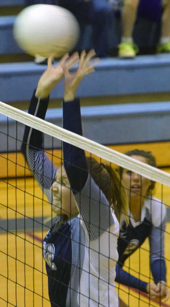 Photo by Jeff Helminiak/Peninsula Clarion Soldotna's Drewe Zeek attempts a block while Cally Christianson backs her up against Colony on Wednesday at Soldotna High School.