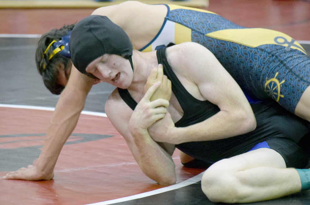Photo by Jeff Helminiak/Peninsula Clarion Soldotna's Talon Musgrave works on Homer's Timmy Woo on Saturday at the Luke Spruill Memorial Tournament at Kenai Central High School. Woo notched a 12-5 victory in the 160-pound match.