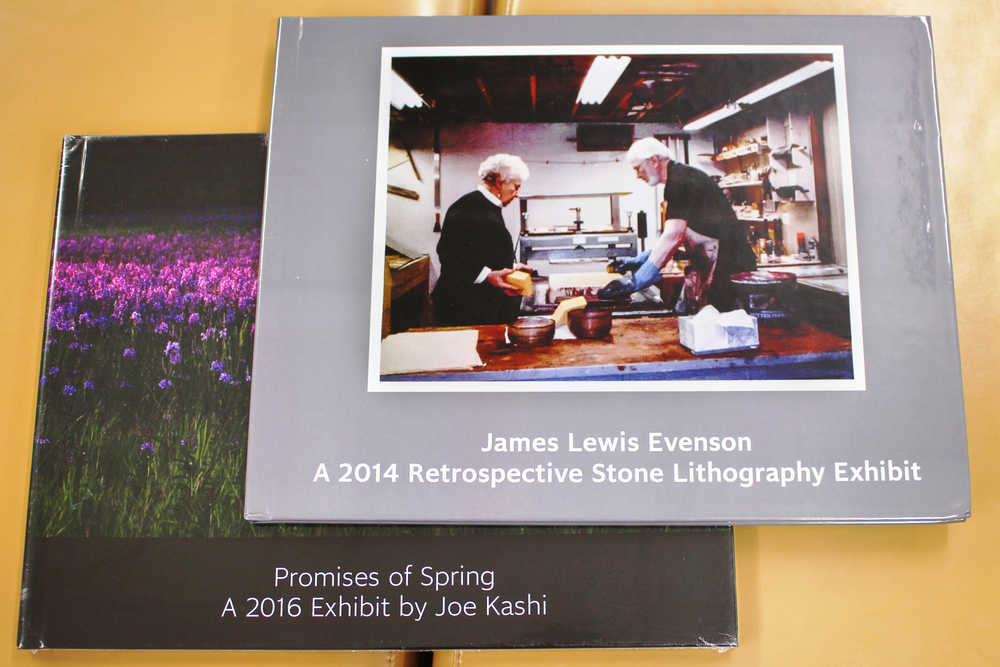 Photo by Ben Boettger/Peninsula Clarion Two of the five large-format books in the Soldotna's Joyce K. Caver Memorial Library's new collection of photo-books by local artists are shown on Wednesday, Oct. 19 in the Soldotna library. The five books presently in the collection - two featuring lithographs by Jim Evenson and three of photography by Joe Kashi - haven't yet been cataloged and shelved. Kashi, director of arts nonprofit ARTSpace, hopes local artists will contribute books to expand the collection by attending an art reproduction training session he's hosting at the Soldotna Library on Saturday.