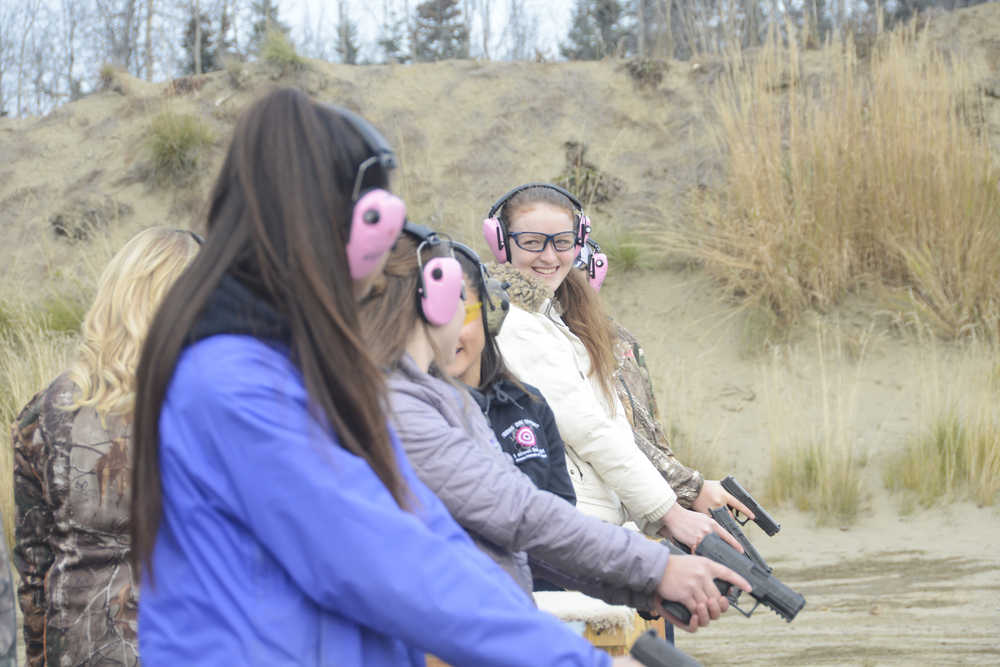 Photo by Megan Pacer/Peninsula Clarion Matthea Boatright, 16, smiles down the line as she and other members of this year's Teens on Target program prepare for a drill to practice shooting handguns Thursday, Oct. 20, 2016 at the Snowshoe Gun Club Range in Kenai, Alaska.