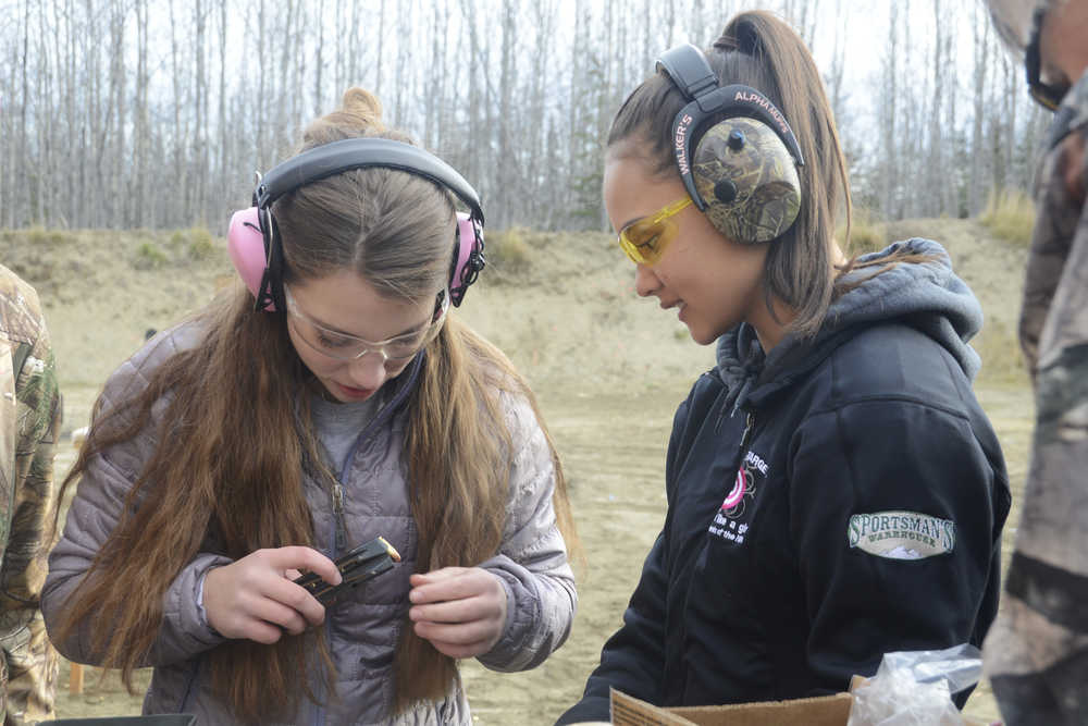 Photo by Megan Pacer/Peninsula Clarion Morgan Reynolds, left, and Faith Glassmaker check a magazine while they load it along with other members of this year's Teens on Target program Thursday, Oct. 20, 2016 at the Snowshoe Gun Club Range in Kenai, Alaska.