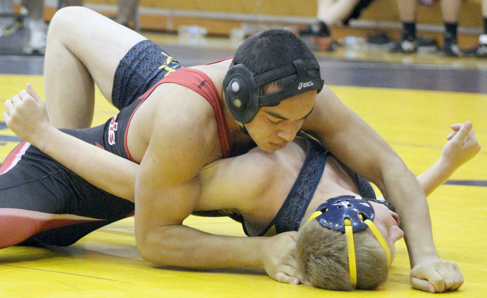 Photo by Anna Frost, Homer News Kenai wrestler Keyshawn McEnerney grapples with Homer wrestler Ryan Hicks as he attempts to pin him down during a match at Homer High School on Saturday, Oct. 22.
