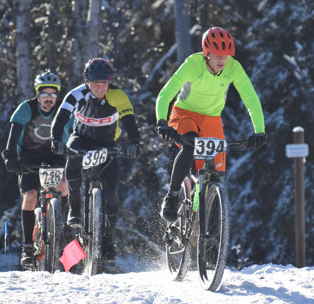 Photo by Joey Klecka/Peninsula Clarion Tyle Owens (394) leads Jacque Drumm (396) and Nathan Kincaid over a hill midway through the course Saturday afternoon at the Tsalteshi Trails.