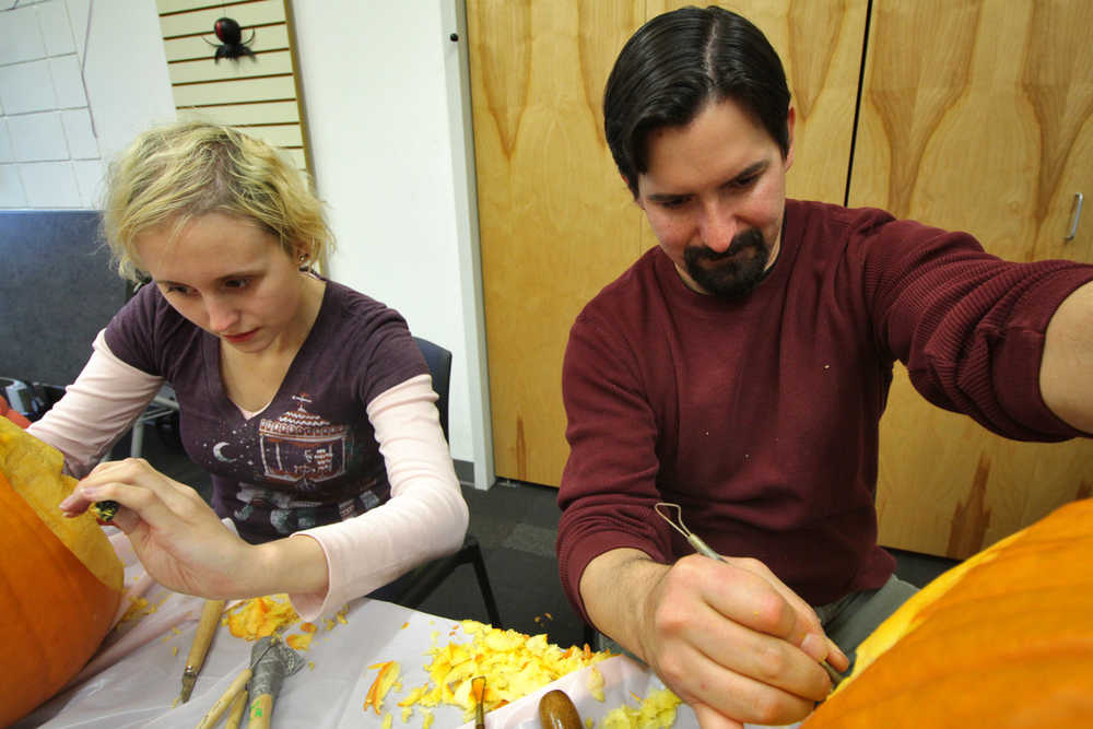 Photo by Ben Boettger/Peninsula Clarion Ivy Howland (left) and Kenai Community Library children's librarian James Adcox work on pumpkin sculptures during a pumpkin-carving session on Tuesday, Oct. 25 in Kenai. Other Halloween activities at the Kenai library include a literary haunted house - inspired by horror classics such as "Frankenstein," "Dracula," "The Legend of Sleepy Hollow," and Edgar Allen Poe's "The Raven" - open from 4 p.m to 6 p.m on Wednesday and Monday, and from 4 p.m to 5:30 p.m on Friday.
