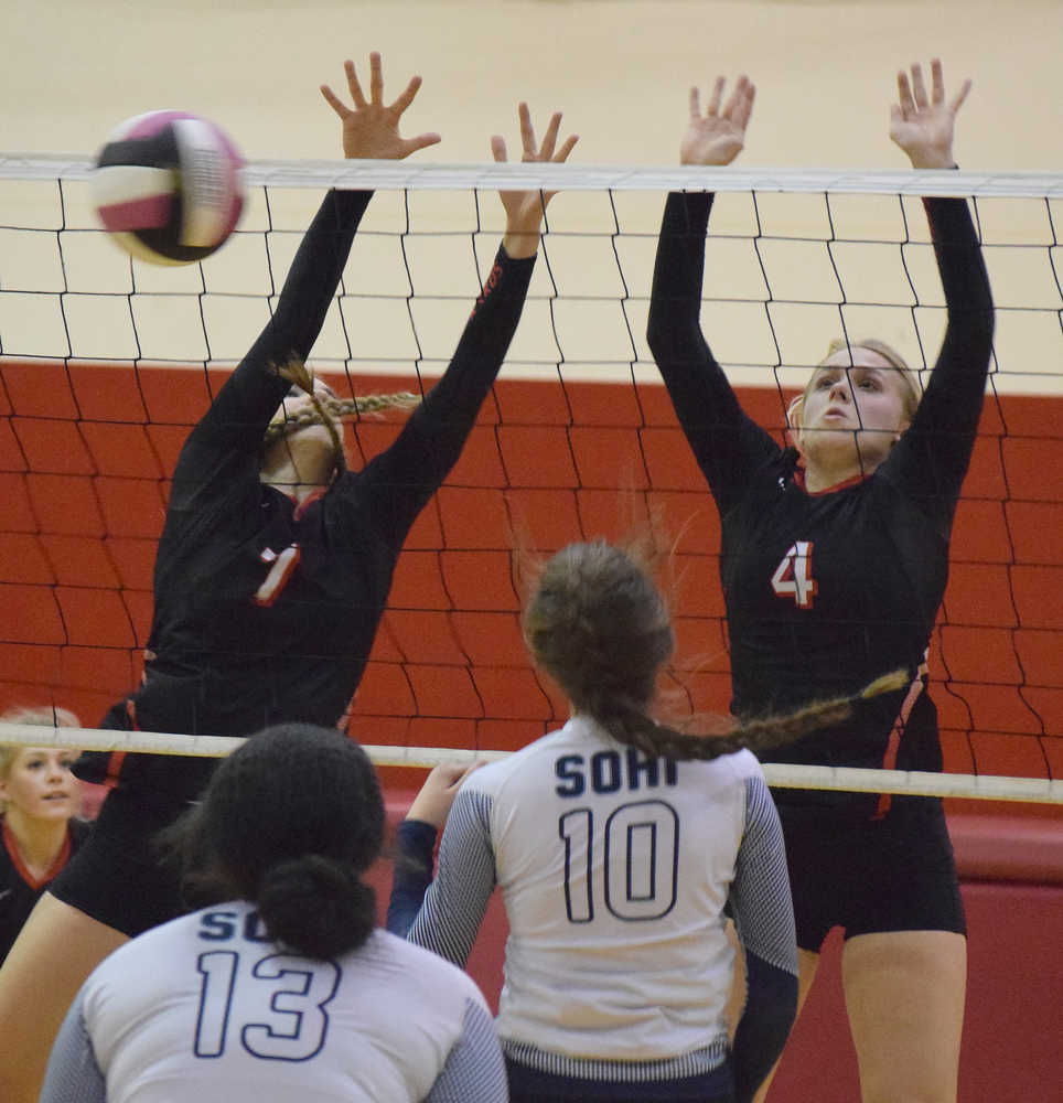 Photo by Joey Klecka/Peninsula Clarion Kenai Central middle blocker Cierra King (7) and Caleigh Jensen form a block from Soldotna Tuesday night at Kenai Central High School.