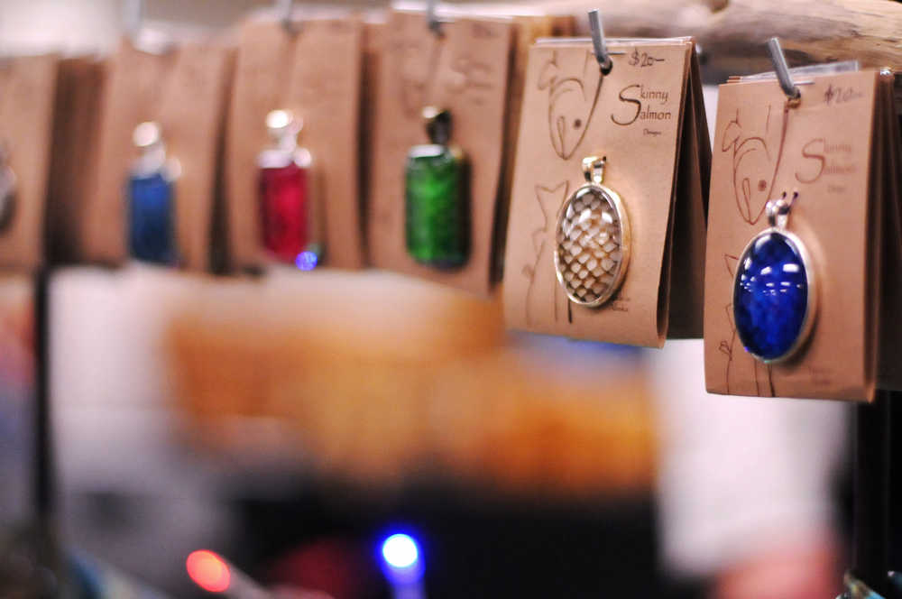 Photo by Elizabeth Earl/Peninsula Clarion Christie Abbott's "Skinny Salmon" necklaces hang on display at the Central Peninsula Hospital Auxiliary Bazaar on Thursday, Nov. 3, 2016 in Soldotna, Alaska. Abbott makes the jewelry out of real salmon skin that she treats, colors and sets into the necklaces, earrings, rings and bracelets herself. The skin comes from salmon she and her husband catch - depending on how the season goes, it's mostly either sockeye or coho salmon, she said. The necklaces are also regularly for sale at Trustworthy Hardware and Fishing in Soldotna. The bazaar continues Friday, Nov. 4, 2016 from 10 a.m. to 3 p.m.