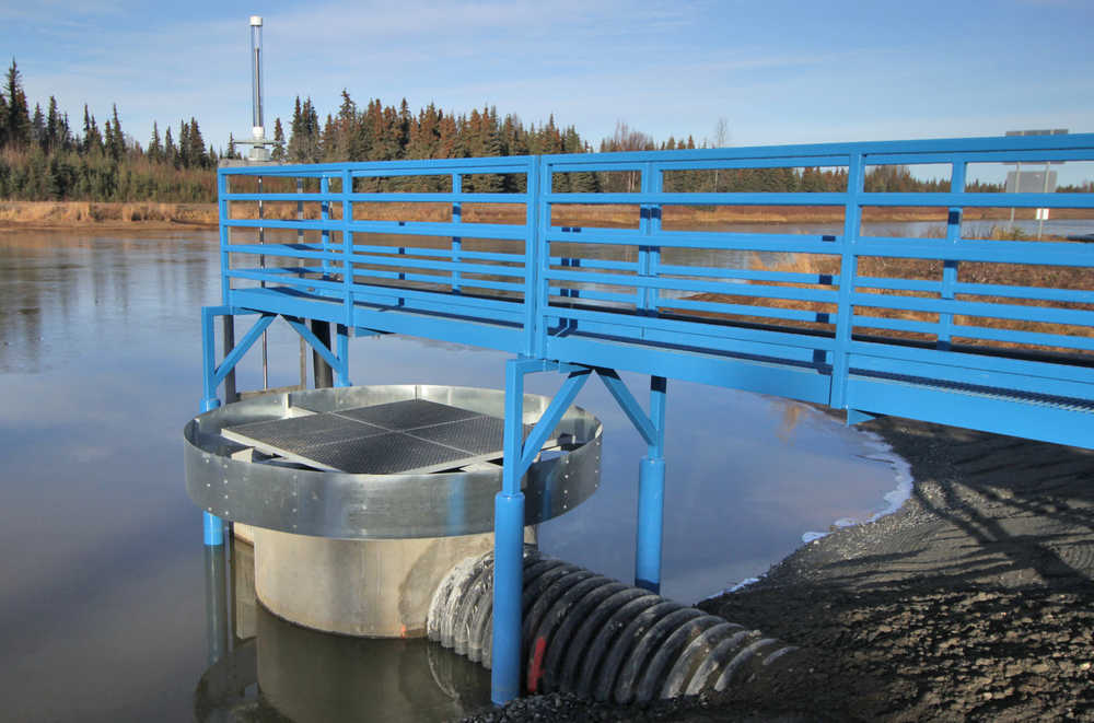 Photo by Ben Boettger/Peninsula Clarion A new drainage outlet holds the Kenai Municipal Airport floatplane pond to its winter level of about 4 feet on Thursday, Nov. 3 in Kenai, Alaska. When filled to its summer level, the upper grate, surrounded by a ring-shaped barrier, will prevent it from overflowing.
