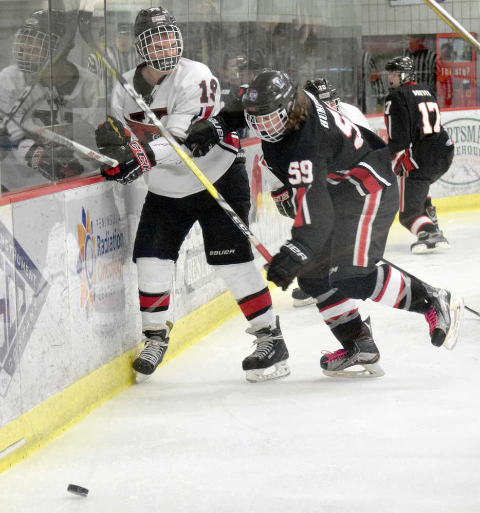 Photo by Jeff Helminiak/Peninsula Clarion Kenai Central's Matthew Zorbas and Houston's Ree Humphreys tangle along the boards Friday at the Soldotna Regional Sports Complex during the Peninsula Ice Challenge.