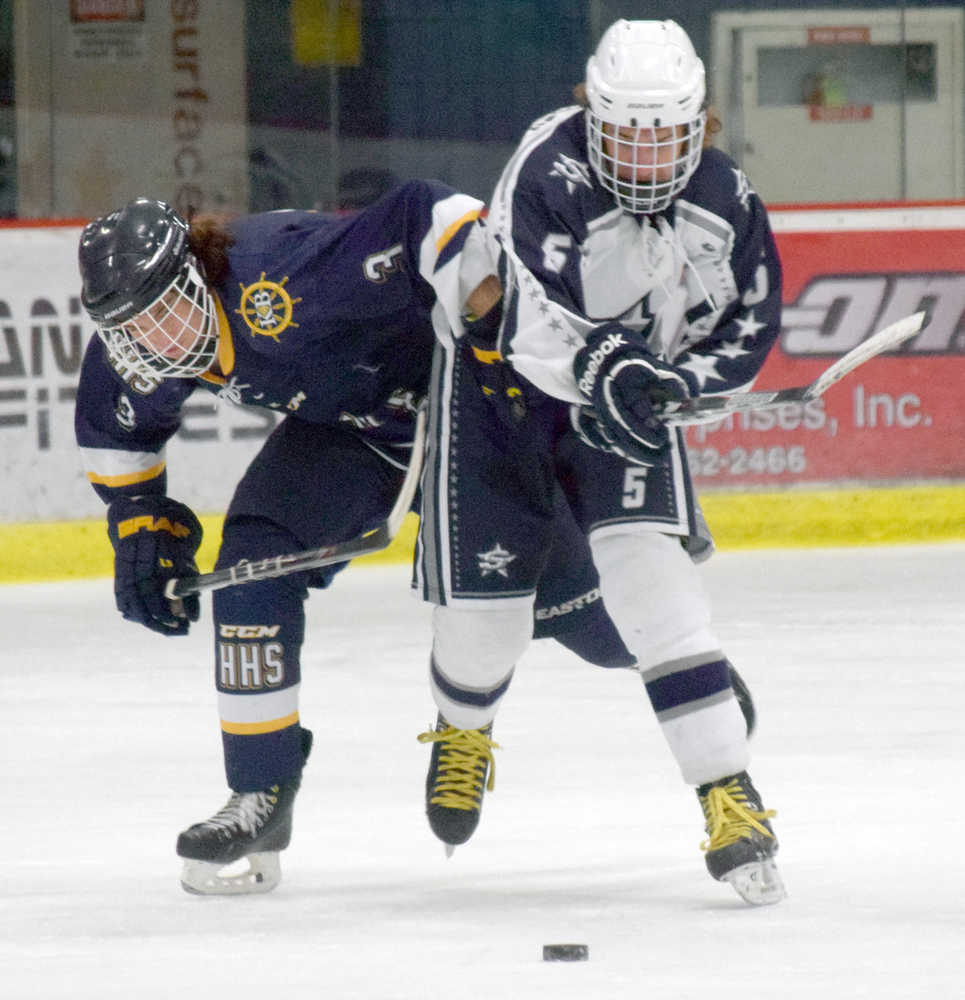 Photo by Jeff Helminiak/Peninsula Clarion Homer's Woape Hoffman and Soldotna's Matthew Daugherty battle for the puck Friday at the Soldotna Regional Sports Complex in Peninsula Ice Challenge action.