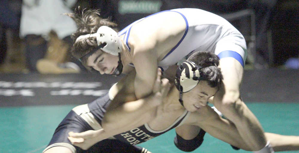 South Anchorage's Micah Ee takes a shot on Gideon Hutchison during the 113-pound final of the Colony Invitational Saturday in Palmer. Hutchison won the match by injury default.