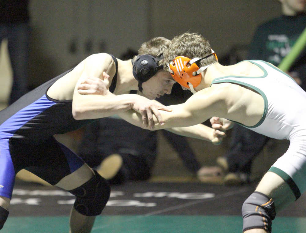 Soldotna's Brayde Wolf locks up with Colony's Sam Sisco during the 126-pound final of the Colony Invitational Saturday night at Colony High School. Sisco won the match 11-0.