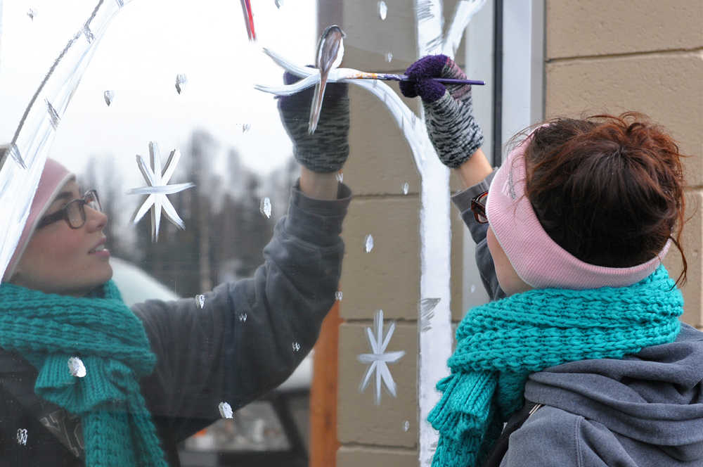 Photo by Elizabeth Earl/Peninsula Clarion Kareasa McElwain of Soldotna paints the front windows of the Kenai Specialty Clinics on Trading Bay Road on Monday, Nov. 7, 2016 in Kenai, Alaska. McElwain, who teaches painting classes through her business K Maria Arts, began offering custom window decoration for businesses this winter. She said she's done about 10 so far this season.