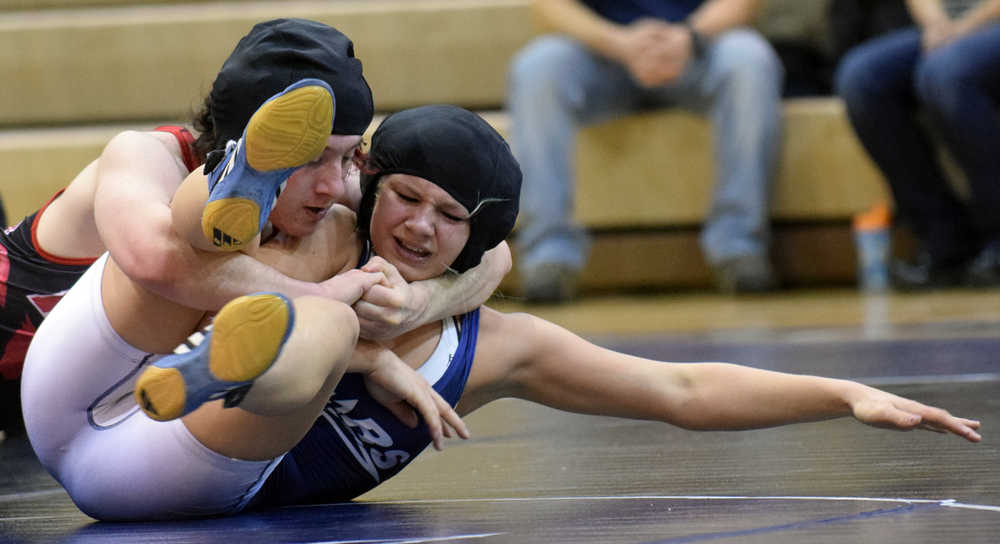 Photo by Jeff Helminiak/Peninsula Clarion Kenai Central's Keaton Logston works his way to a pin over Soldotna's Amanda Wylie on Thursday in a dual meet at Soldotna Prep.