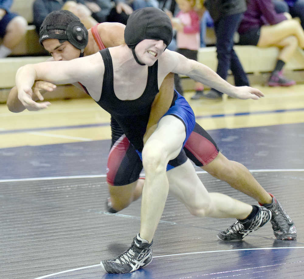 Photo by Jeff Helminiak/Peninsula Clarion Soldotna's Talon Musgrave tries to escape from Kenai Central's Keyshawn McEnerney on Thursday at Soldotna Prep. McEnerney won by major decision in the 160-pound match.