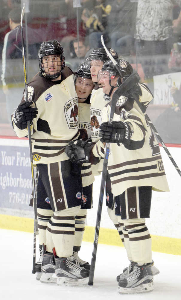 Photo by Jeff Helminiak/Peninsula Clarion Christopher Lipe, Luke Radetic, Lucas Carroll and Jonathan Marzec celebrate Radetic's goal in the second period Friday at the Soldotna Regiona Sports Complex.