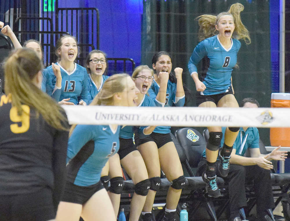Photo by Joey Klecka/Peninsula Clarion Nikiski's Kaitlyn Johnson (8) jumps up in excitement along with the Nikiski bench Friday evening at the Class 3A state volleyball tournament at the Alaska Airlines Arena in Anchorage.