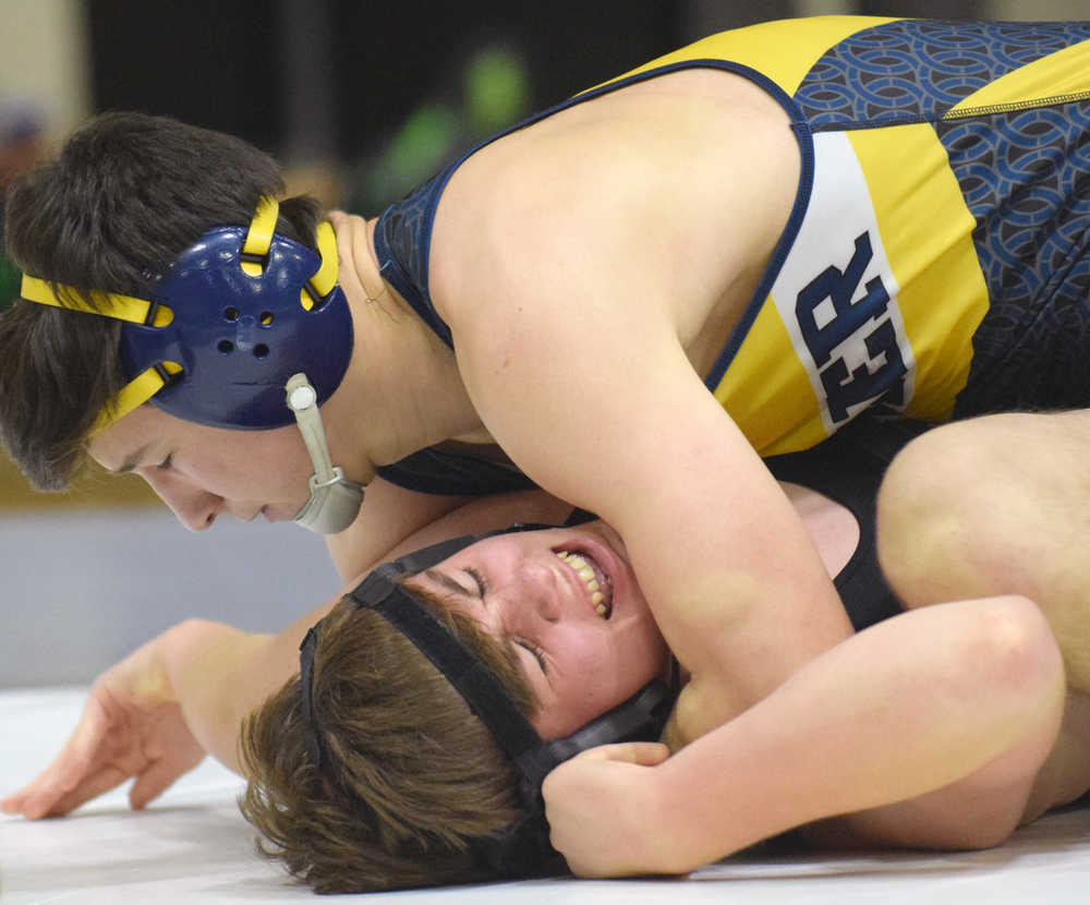 Photo by Jeff Helminiak/Peninsula Clarion Homer's Timmy Woo prepares to pin Colony's Frank Urbano at 160 pounds Saturday in the championship dual of the Peninsula Duals at Nikiski High School.