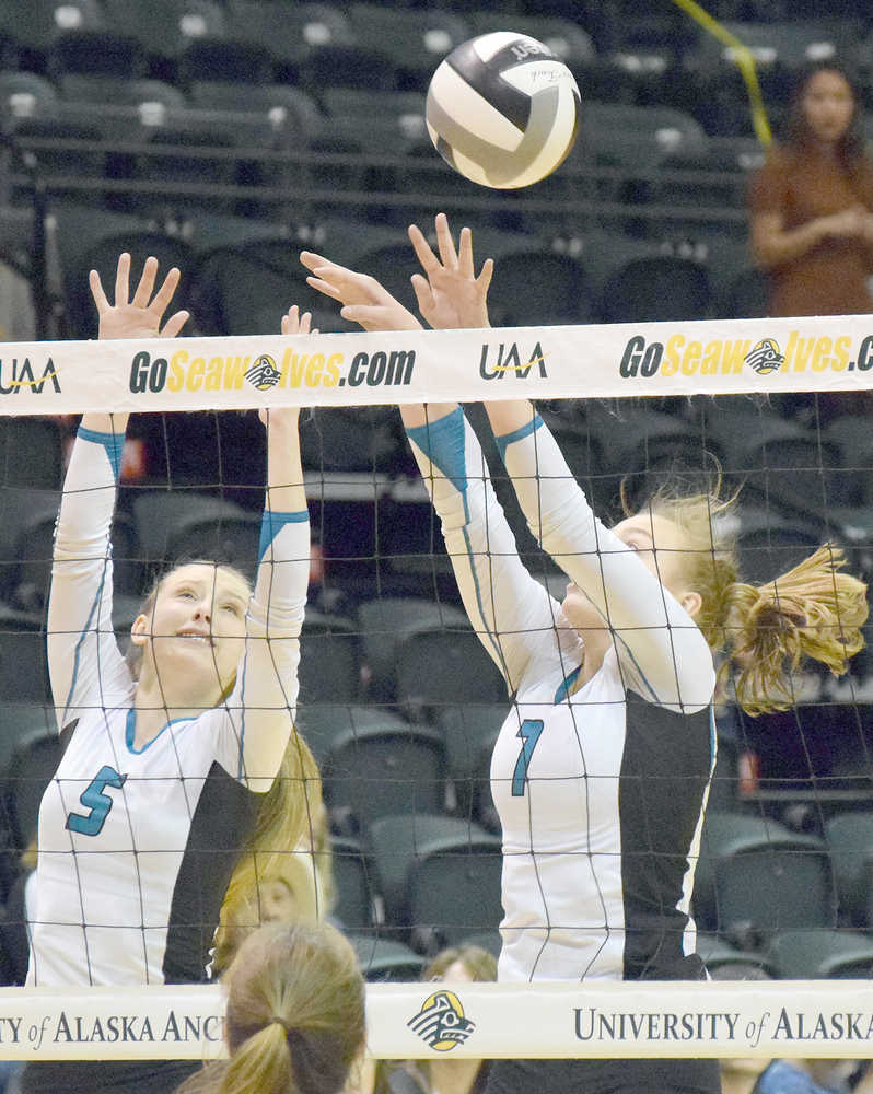 Photo by Joey Klecka/Peninsula Clarion Nikiski's Emily Hensley (5) and Bethany Carstens team up for a block against Mt. Edgecumbe in Saturday's Class 3A state volleyball championship at the Alaska Airlines Arena in Anchorage.