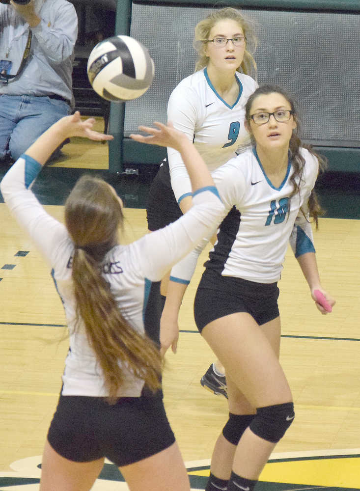Photo by Joey Klecka/Peninsula Clarion Nikiski senior Ayla Pitt (center) and junior Jamie Yerkes keep an eye on the set play by sophomore Emma Wik against Mt. Edgecumbe in the Class 3A state volleyball championship Saturday at the Alaska Airlines Arena in Anchorage.